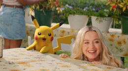 Katy Perry and a female Pikachu looking from a table