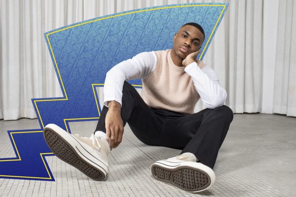 Picture of Vince Staples sitting with a blue Pikachu tail in the background