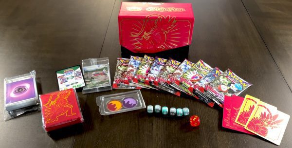 The contents of the Scarlet & Violet Elite Trainer Box, with sleeves, Basic Energy, 9 booster packs, damage counter dice, and more