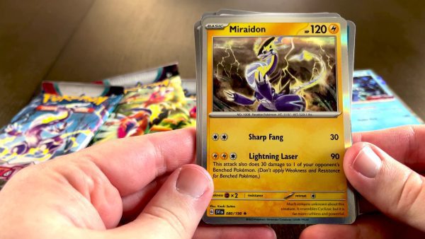 Marriland opening a booster pack with Miraidon in it